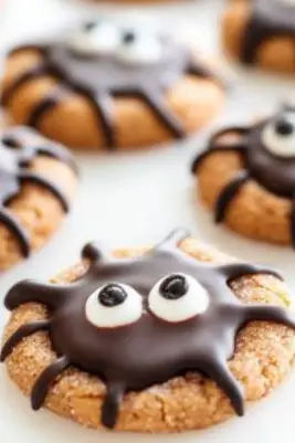 Halloween Spider Cookies – Cute and spooky peanut butter cookies with Reese’s cups, candy eyes, and chocolate legs. Perfect for parties!

