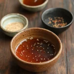 Various ingredients for yakisoba sauce, including soy sauce, Worcestershire sauce, oyster sauce, ketchup, and seasonings, arranged on a kitchen counter