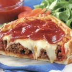 Deep dish pizza slice with cheese stretching out